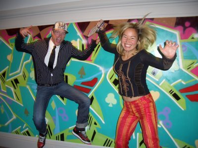 Mike Weber and Philippa Hughes jumping for joy in front of Tim Conlon’s work 