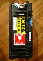a black case with yellow stickers on it