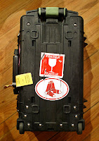 a black suitcase with a sticker on it