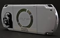 a white gaming device with a silver circle