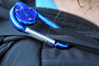 a close up of a blue carabiner