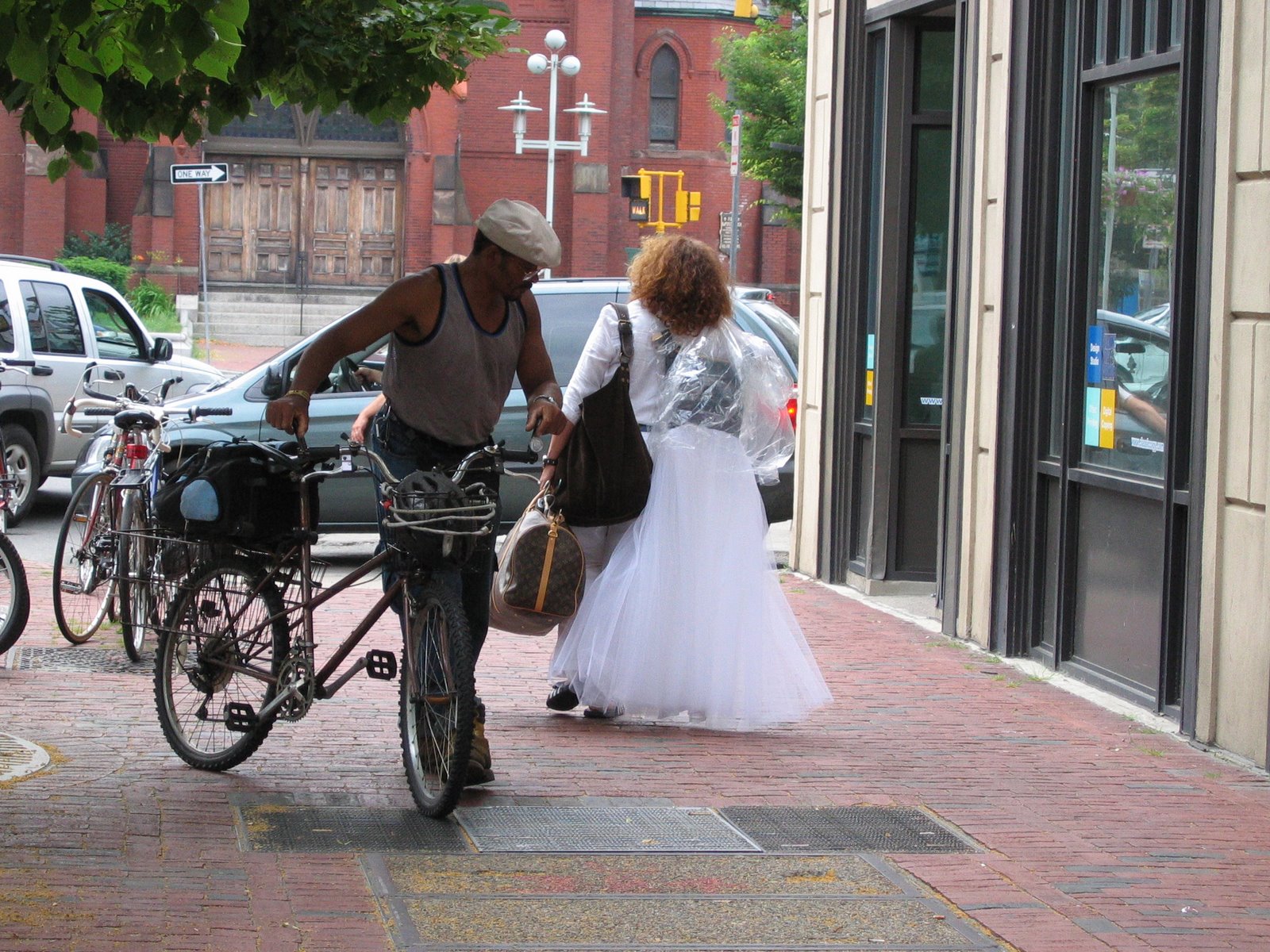 [Man+Mounting+Bicycle+On+Sidewalk.JPG]