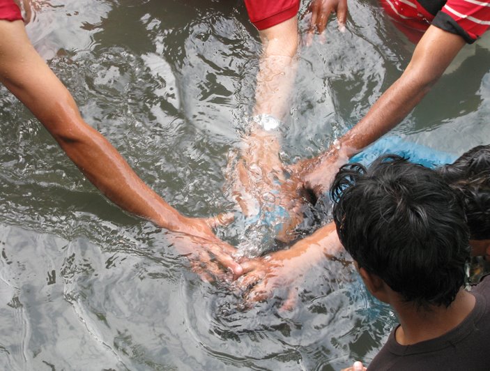 [eMi-I1184+Lacheewala-Baptism+HandsUnderWater.jpg]