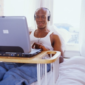 [man_in_bed_on_computer.jpg]