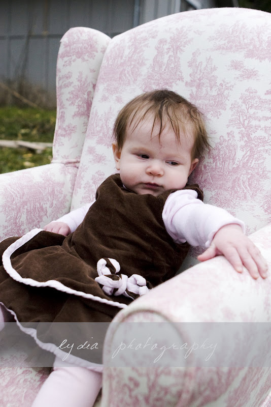 Baby in a pink chair at lifestyle baby portraits in Grass Valley, California