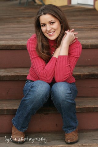 Senior with her hands together sitting on the steps at lifestyle senior portraits in Colfax, California