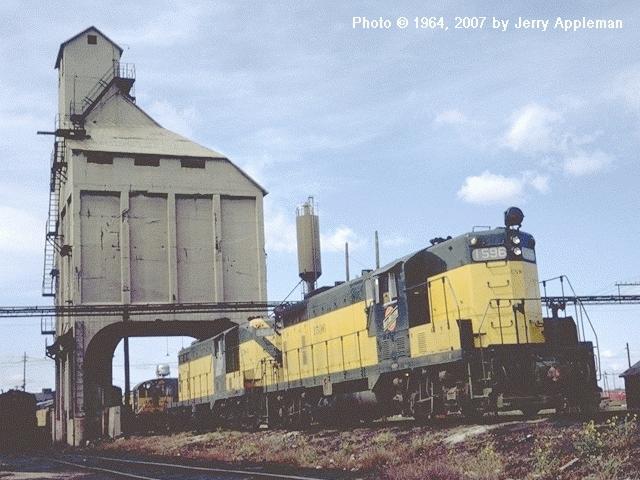 [Chicago+&+North+Western+1596+(GP7)+and+1584+(GP7)+sit+in+front+of+the+coal+dock+in+Chicago,+Illinois..jpg]