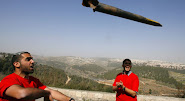Israeli Protester throws remains of a Rocket