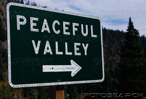 [this-is-a-road-signs-that-says-peaceful-valley-there-is-white-arrow-~-73070473.jpg]