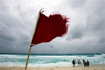 [A+red+flag+flutters+at+Cancun's+beach+as+Hurricane+Emily+approaches.jpg]