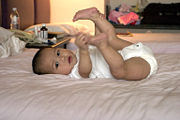 [180px-Baby_holding_feet.jpg]