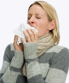 [woman+sneezing+into+a+tissue.jpg]