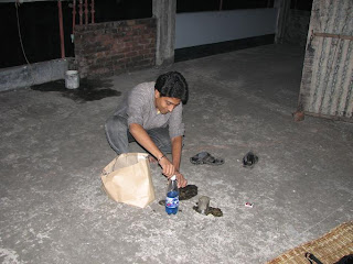 Razib is preparing the torch with sand and kerosene