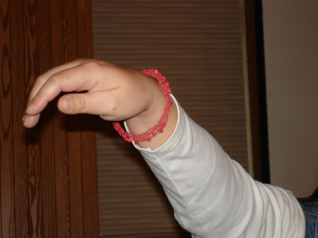 [Holly wearing her knitted bracelet.jpg]