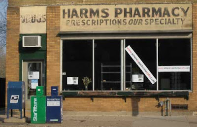 Storefront with early to mid-20th century sign that reads Harms Pharmacy