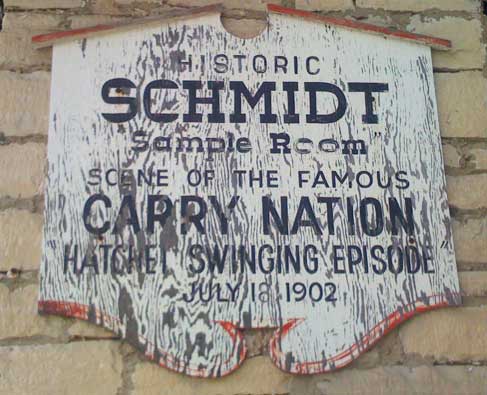 Weathered hand-painted sign reading Scene of the famous 1902 Carry Nation hatchet swinging episode