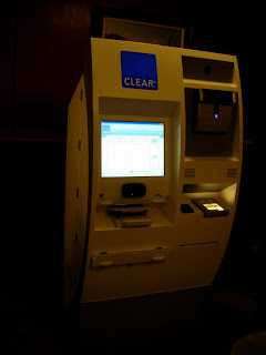 a white atm machine with a screen