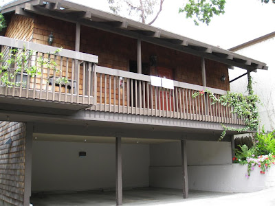 a house with a garage and a balcony