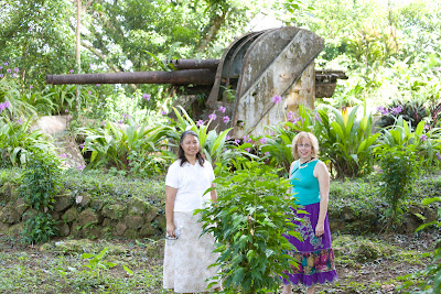 Donna McNear and Mary Kidd in front of a ruined Japanese gun in the jungle