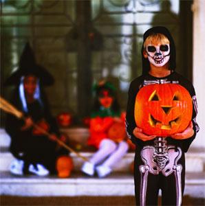 [portrait-of-a-child-dressed-up-as-a-skeleton-and-holding-a-pumpkin-on-~-57563744.jpg]
