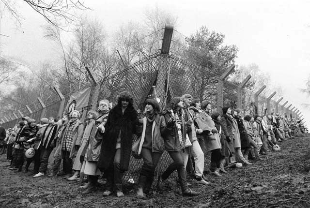 [Women_link_arms_at_Greenham_Common_in_1982._Photograph_PA.jpg]