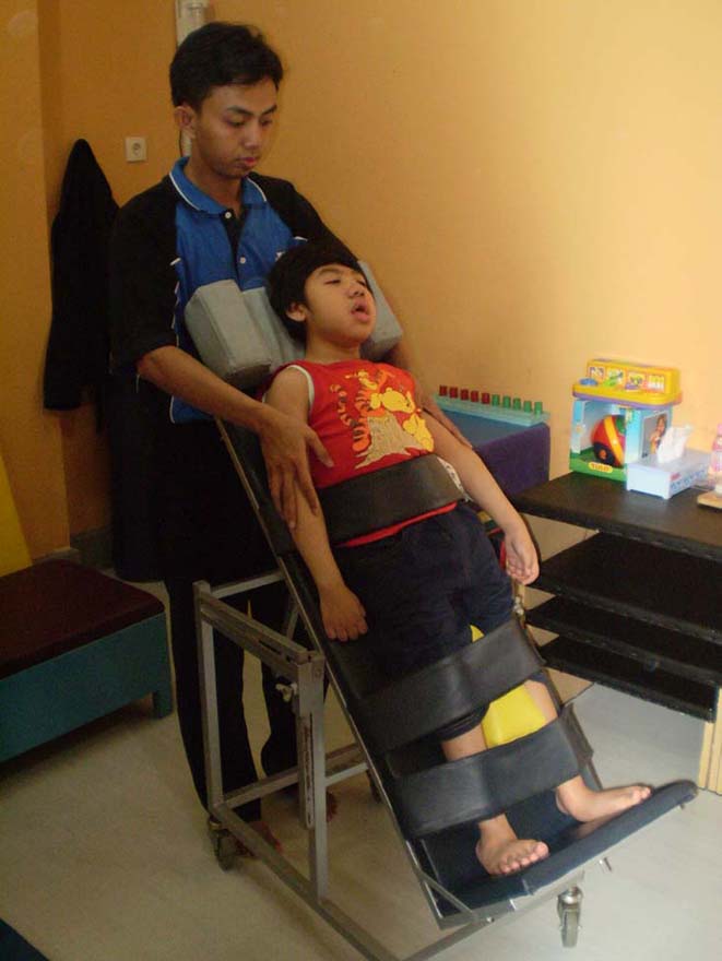 [A+therapist+gives+therapy+using+standing+frame+to+4.5+year+old+boy+with+quadriplegic+CP+ALPHA+AMIRRACHMAN.jpg]
