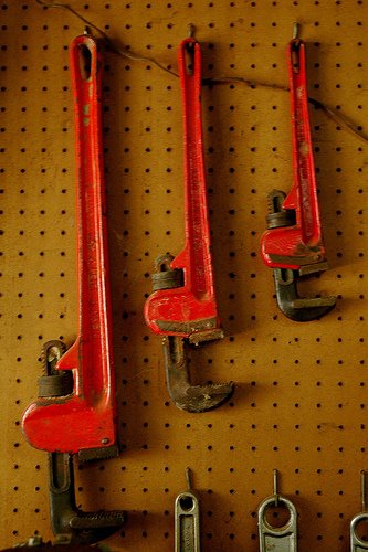 wrenches hanging from pegboard