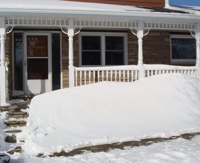 Snow drift in front of house