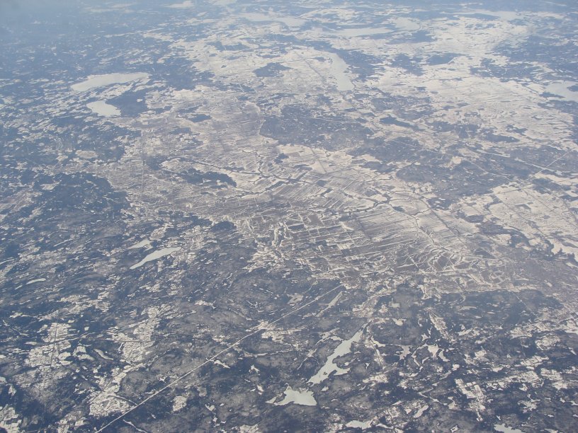 Aerial view of farmland surrounded by forest, north of Ottawa