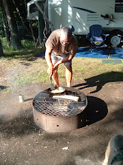 Dad cooking over a wood fire.
