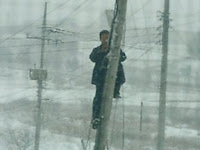Korea Telecom Serviceman Installing DSL Service during February 2005 Snowfall in rural Kangwon Province