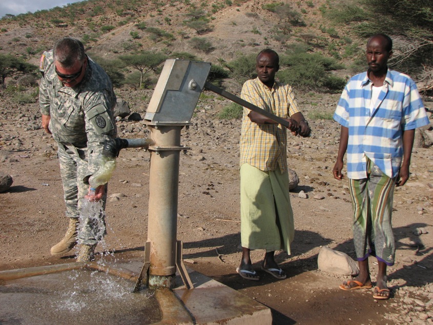 [Soldier+and+Locals+at+Water+Pump.jpg]